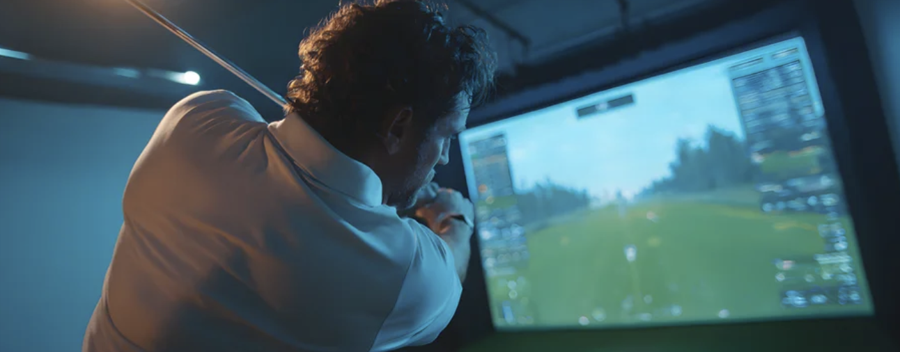 Golfer swinging in simulator